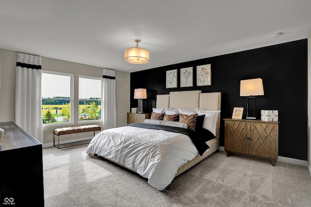 bedroom featuring carpet and baseboards