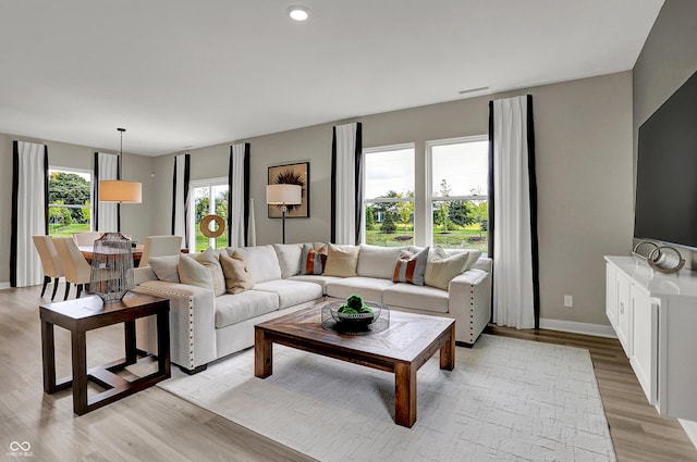 living room with light wood finished floors and baseboards