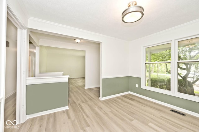 19446 Ethan Allen Ln, Westfield, IN 46074 - empty room with wood finished floors, baseboards, crown molding, and a textured ceiling