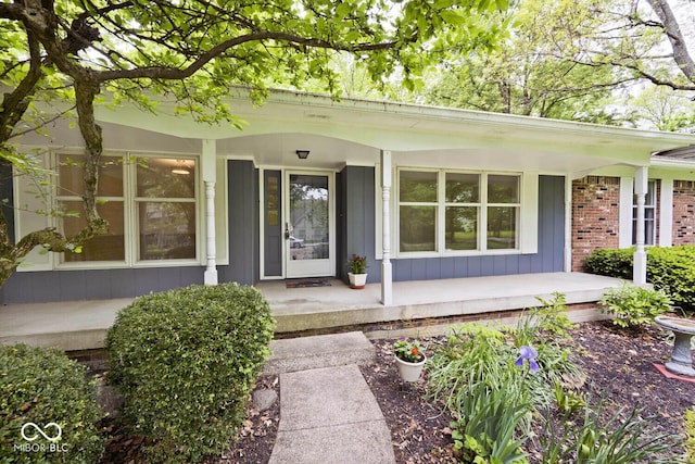 19446 Ethan Allen Ln, Westfield, IN 46074 - view of exterior entry with covered porch, board and batten siding, and brick siding