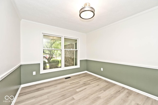 19446 Ethan Allen Ln, Westfield, IN 46074 - empty room featuring wood finished floors, baseboards, crown molding, and a textured ceiling