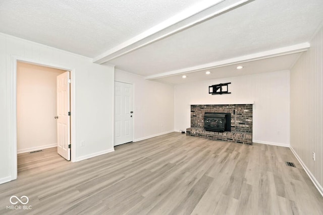 19446 Ethan Allen Ln, Westfield, IN 46074 - unfurnished living room with beam ceiling, a wood stove, light wood-style floors, recessed lighting, and baseboards