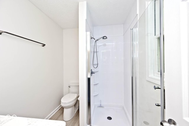 19446 Ethan Allen Ln, Westfield, IN 46074 - bathroom featuring a stall shower, toilet, a textured ceiling, and wood finished floors