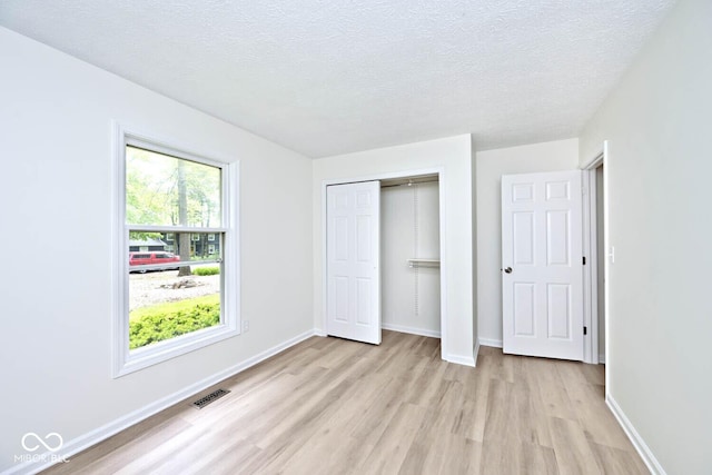 19446 Ethan Allen Ln, Westfield, IN 46074 - unfurnished bedroom featuring light wood-style flooring, a textured ceiling, baseboards, and a closet