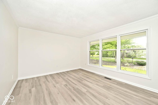 19446 Ethan Allen Ln, Westfield, IN 46074 - spare room featuring light wood-style flooring, crown molding, and baseboards
