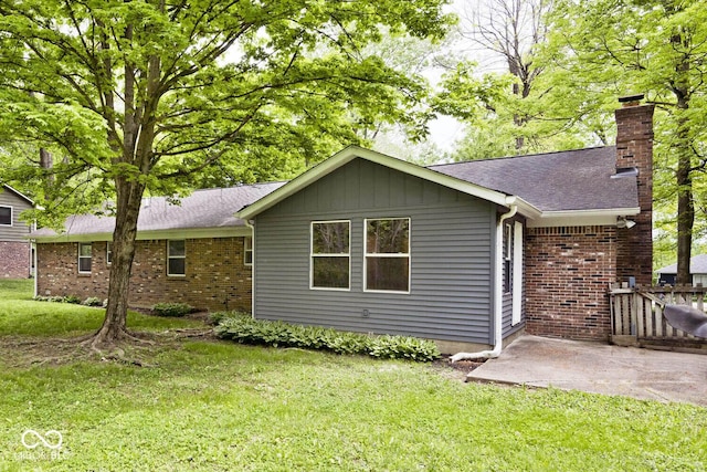 19446 Ethan Allen Ln, Westfield, IN 46074 - rear view of house with a chimney, a lawn, a patio, and brick siding