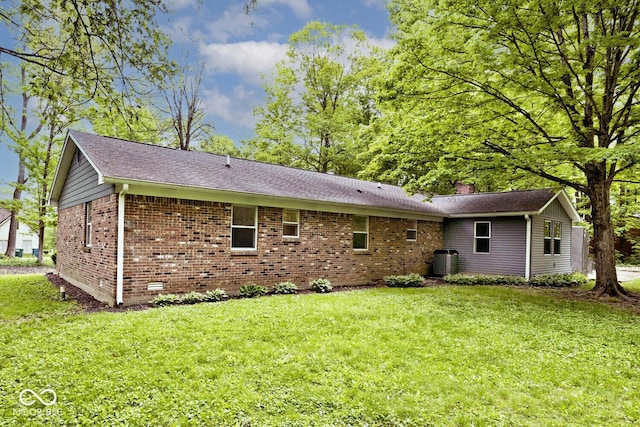 19446 Ethan Allen Ln, Westfield, IN 46074 - back of property featuring brick siding, a lawn, central AC unit, a shingled roof, and a chimney