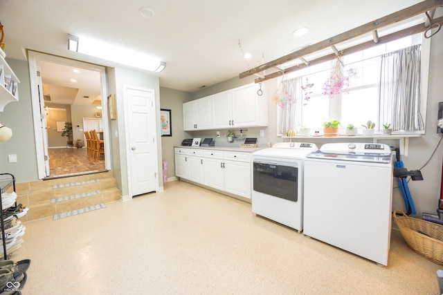kitchen featuring washer and dryer, white cabinetry, light countertops, and recessed lighting