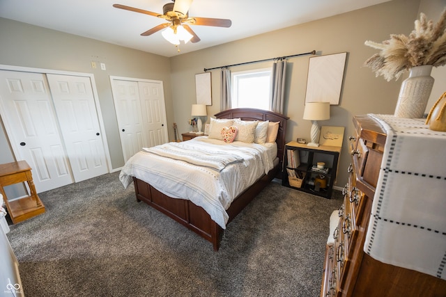 bedroom featuring dark colored carpet, multiple closets, ceiling fan, and baseboards