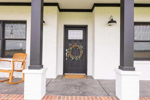 view of exterior entry featuring a porch