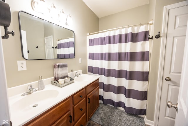 bathroom featuring double vanity and a shower with curtain