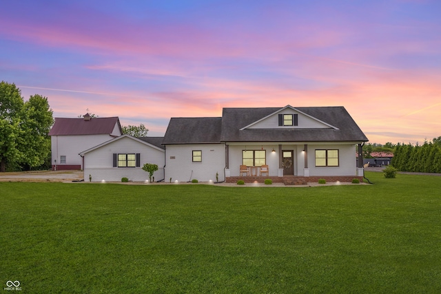 modern farmhouse with a porch, a lawn, and roof with shingles
