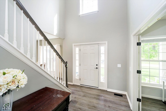 14130 Autumn Woods Dr, Carmel, IN 46074 - foyer featuring stairway, a high ceiling, wood finished floors, and baseboards
