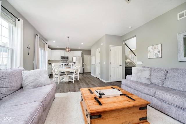 14130 Autumn Woods Dr, Carmel, IN 46074 - living area featuring dark wood finished floors, recessed lighting, stairway, and baseboards
