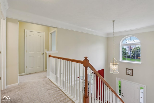 9311 Windrift Way, Zionsville, IN 46077 - hallway featuring an upstairs landing, crown molding, carpet flooring, and a chandelier