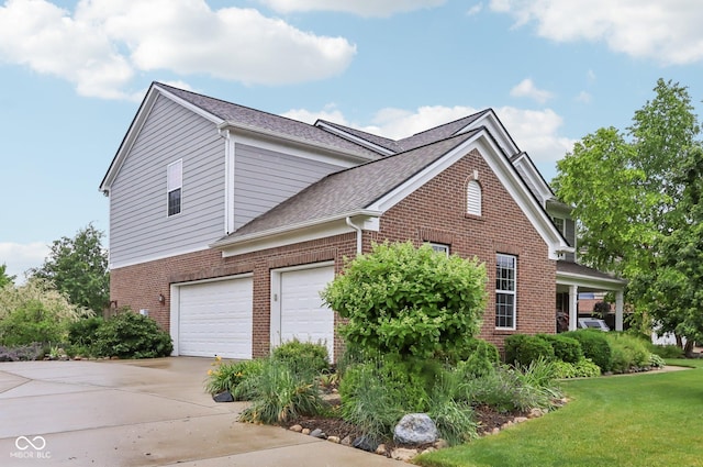 9311 Windrift Way, Zionsville, IN 46077 - view of property exterior featuring brick siding, driveway, a lawn, and roof with shingles