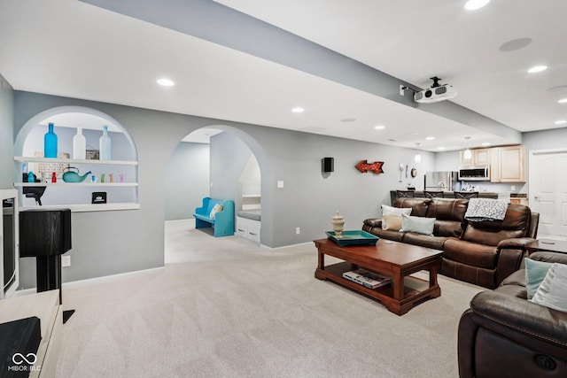 9311 Windrift Way, Zionsville, IN 46077 - living room featuring recessed lighting, light carpet, and arched walkways