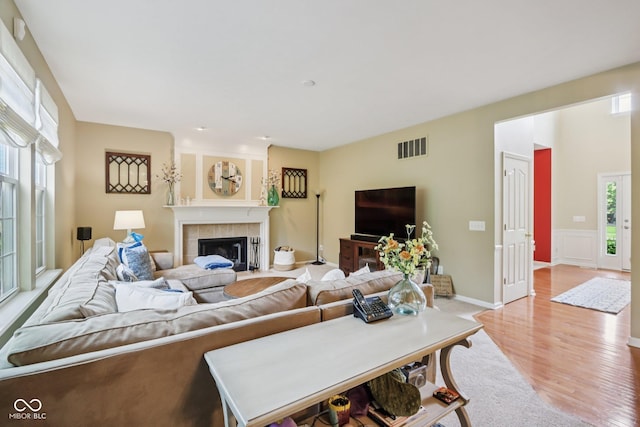 9311 Windrift Way, Zionsville, IN 46077 - living room with healthy amount of natural light, light wood-style floors, and a fireplace