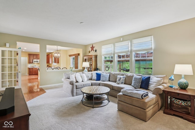 9311 Windrift Way, Zionsville, IN 46077 - living room featuring light carpet and a chandelier