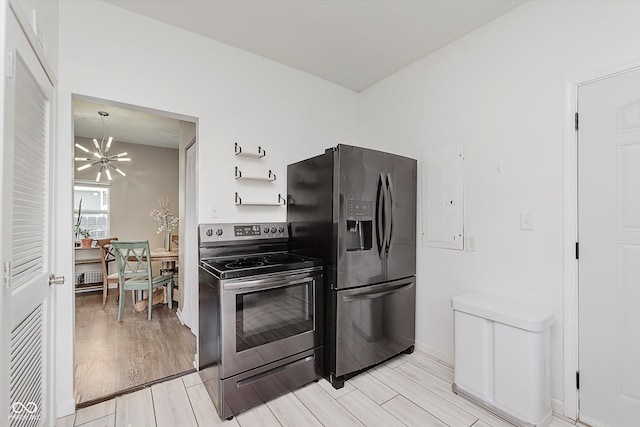 2230 Pleasant St, Indianapolis, IN 46203 - kitchen with stainless steel appliances, a chandelier, and light wood-style flooring