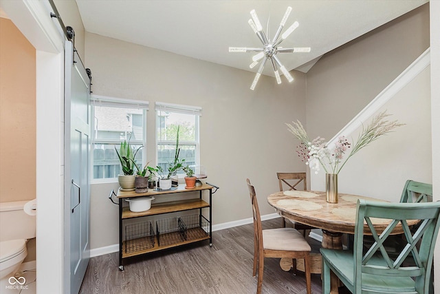 2230 Pleasant St, Indianapolis, IN 46203 - dining area featuring wood finished floors, baseboards, and a barn door