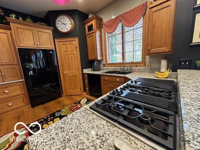 125 Ems B20C Ln, Pierceton, IN 46562 - kitchen with black appliances, a sink, brown cabinets, and wood finished floors