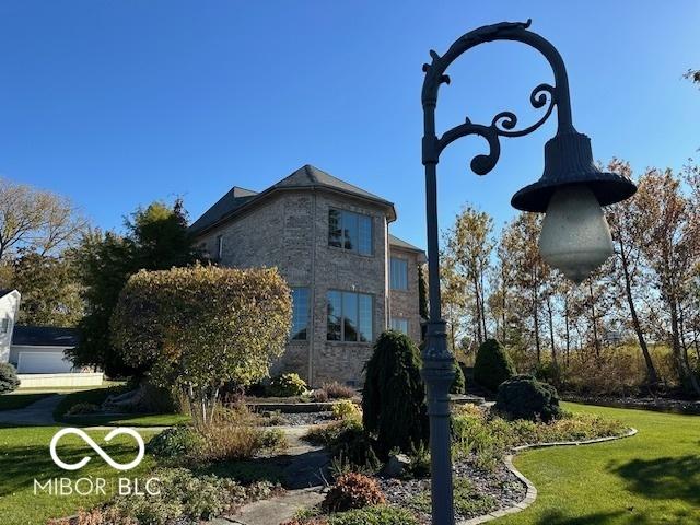 125 Ems B20C Ln, Pierceton, IN 46562 - view of property exterior featuring a lawn and stone siding