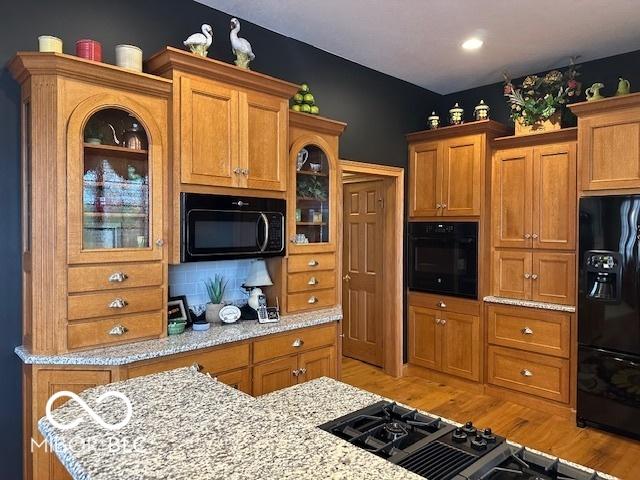 125 Ems B20C Ln, Pierceton, IN 46562 - kitchen with black appliances, brown cabinetry, and light wood finished floors