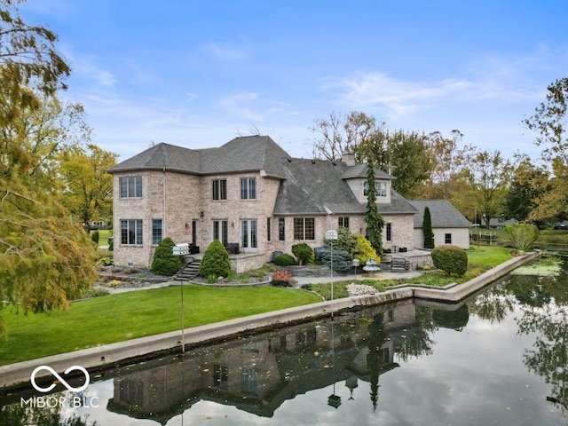 125 Ems B20C Ln, Pierceton, IN 46562 - back of property with a lawn, brick siding, and a water view