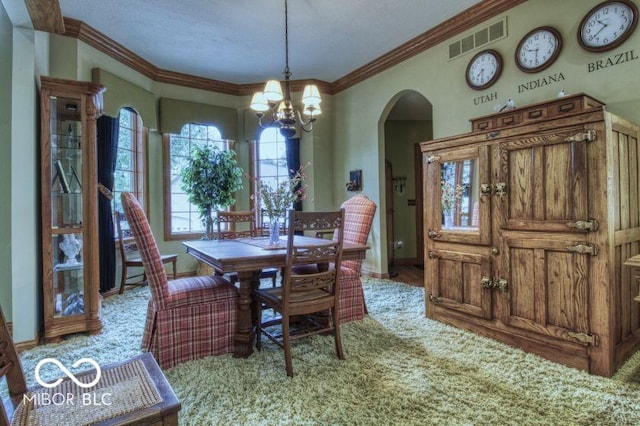 125 Ems B20C Ln, Pierceton, IN 46562 - dining space with arched walkways, a chandelier, crown molding, and baseboards