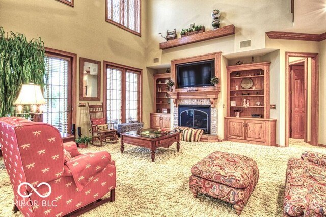 125 Ems B20C Ln, Pierceton, IN 46562 - living room featuring a glass covered fireplace, carpet flooring, and a towering ceiling