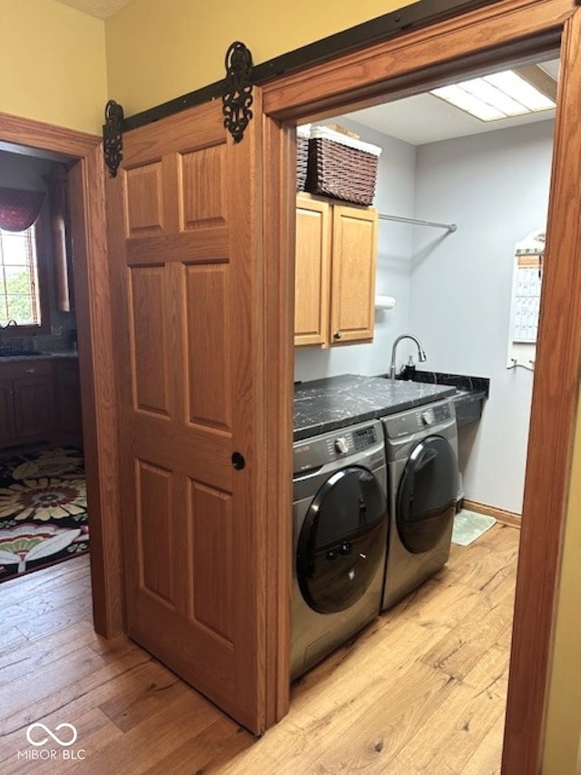 125 Ems B20C Ln, Pierceton, IN 46562 - washroom featuring cabinet space, light wood-style floors, and washing machine and dryer