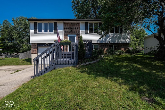 5522 Closser Ct, Indianapolis, IN 46221 - raised ranch with brick siding, driveway, an attached garage, and a front yard