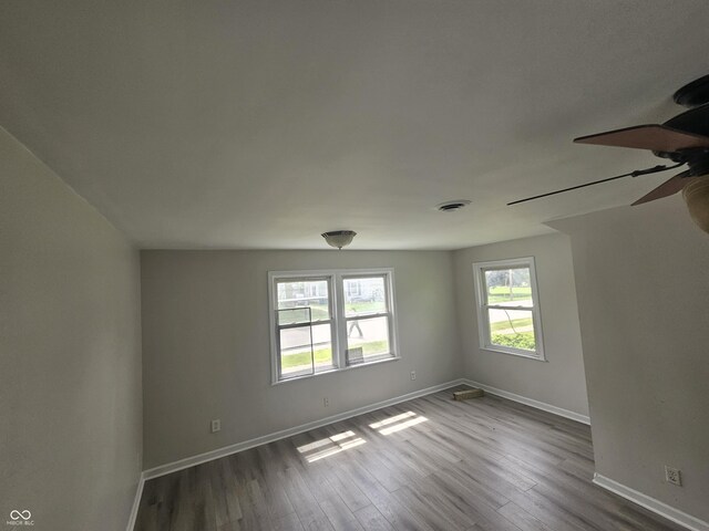 208 S Madison St, Converse, IN 46919 - unfurnished room with baseboards, dark wood-style flooring, and ceiling fan