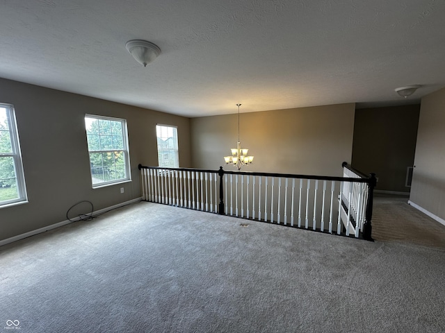 14462 Brook Meadow Dr, Mccordsville, IN 46055 - carpeted empty room with a chandelier, baseboards, and a textured ceiling