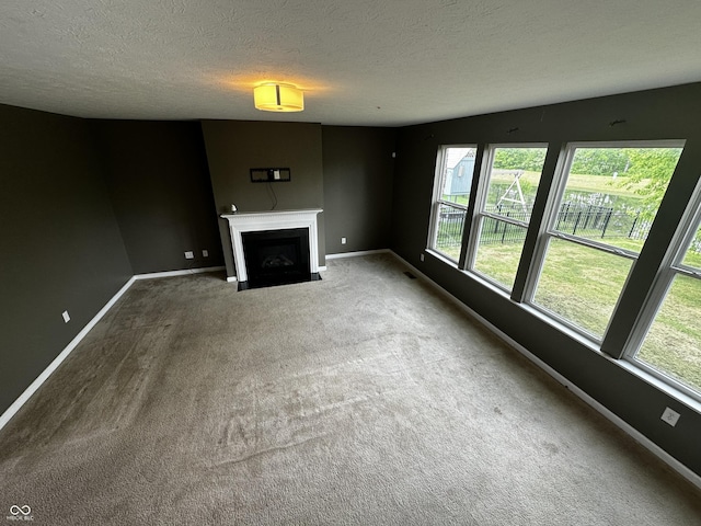 14462 Brook Meadow Dr, Mccordsville, IN 46055 - unfurnished living room featuring carpet floors, baseboards, a fireplace with flush hearth, and a textured ceiling