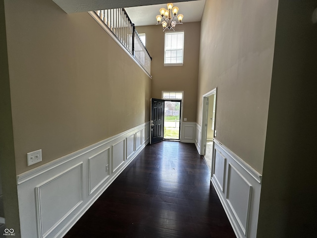 14462 Brook Meadow Dr, Mccordsville, IN 46055 - entryway featuring a decorative wall, a chandelier, a wainscoted wall, dark wood-style floors, and a towering ceiling
