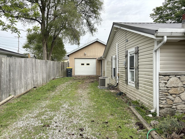 909 Sullivan St, Alexandria, IN 46001 - view of yard featuring driveway, central AC, and an attached garage