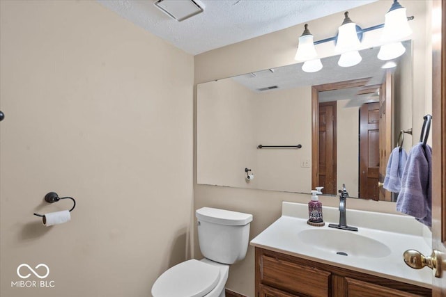 14814 Beacon Blvd, Carmel, IN 46032 - bathroom featuring toilet, vanity, and a textured ceiling