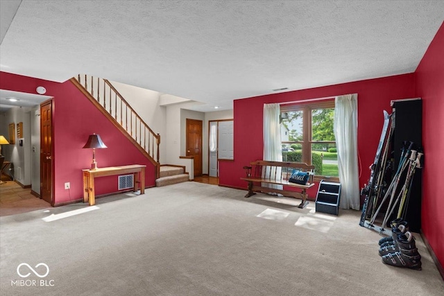 14814 Beacon Blvd, Carmel, IN 46032 - carpeted living room featuring stairway, a textured ceiling, and baseboards