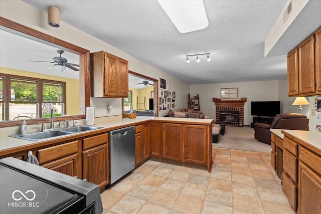 14814 Beacon Blvd, Carmel, IN 46032 - kitchen featuring stainless steel dishwasher, a ceiling fan, a sink, black range, and a fireplace