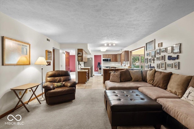 14814 Beacon Blvd, Carmel, IN 46032 - living room featuring a textured ceiling, light colored carpet, and baseboards