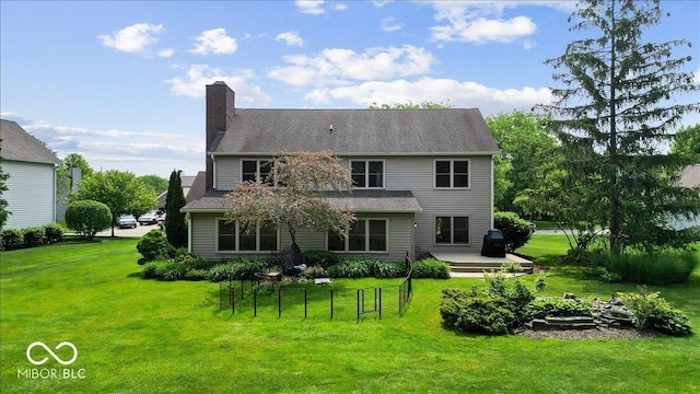 14814 Beacon Blvd, Carmel, IN 46032 - back of house with a lawn, a chimney, and a wooden deck