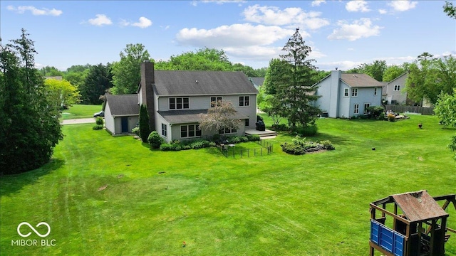 14814 Beacon Blvd, Carmel, IN 46032 - back of house featuring a chimney and a lawn