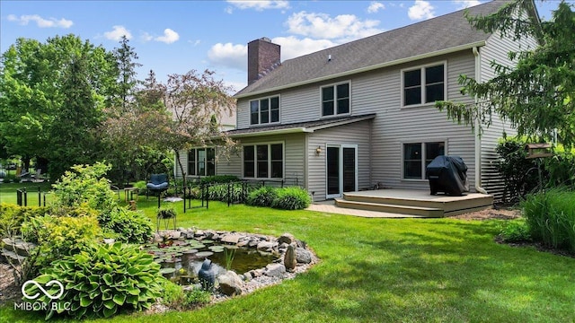14814 Beacon Blvd, Carmel, IN 46032 - back of property featuring a chimney, a deck, and a small pond