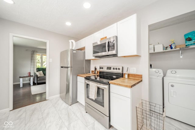 433 N 15th Ave, Beech Grove, IN 46107 - kitchen with stainless steel appliances, independent washer and dryer, wooden counters, white cabinetry, and recessed lighting