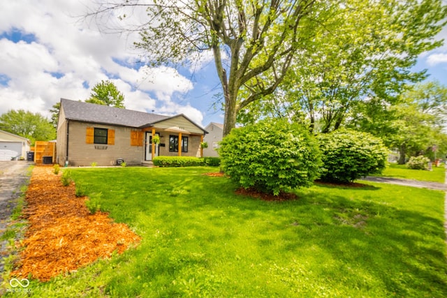433 N 15th Ave, Beech Grove, IN 46107 - view of front of property featuring a front lawn, brick siding, and a garage