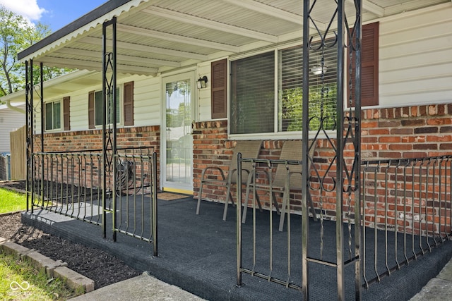 5115 Bertha St, Indianapolis, IN 46241 - property entrance with a porch and brick siding