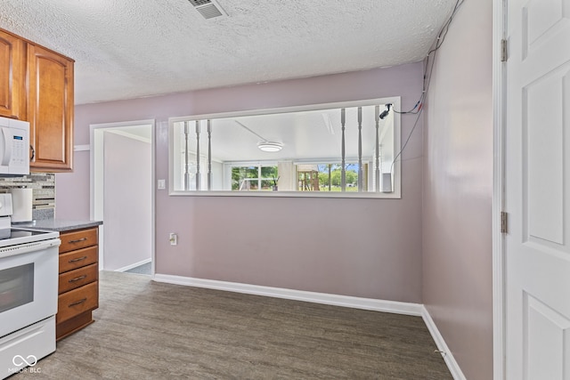 5115 Bertha St, Indianapolis, IN 46241 - kitchen with white appliances, brown cabinetry, wood finished floors, decorative backsplash, and a textured ceiling