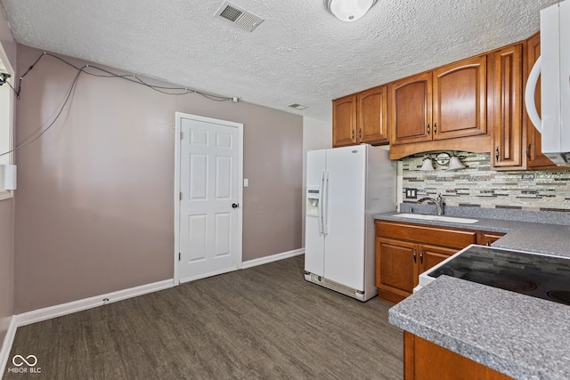5115 Bertha St, Indianapolis, IN 46241 - kitchen featuring white appliances, a sink, brown cabinets, and a textured ceiling